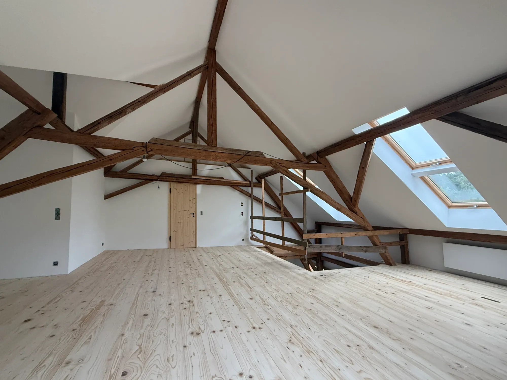 Ausgebauter Dachraum mit Fichtendielen, Holztragwerk und Dachfenstern